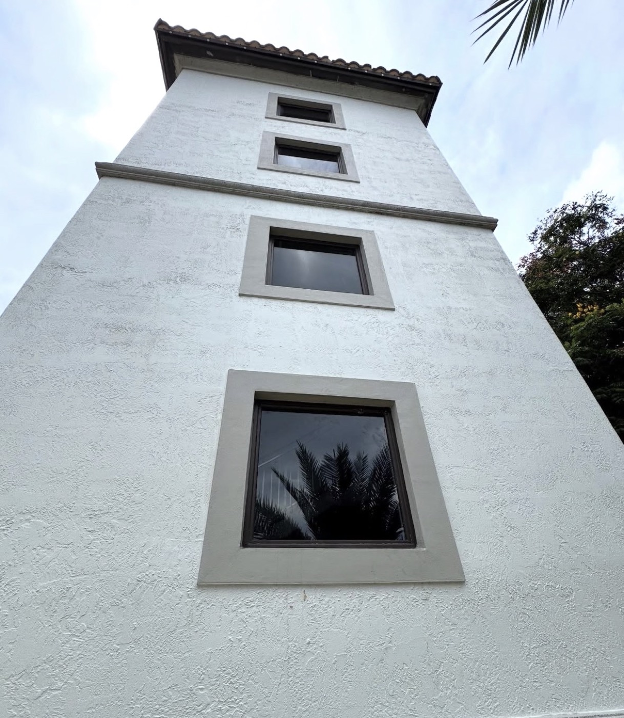 New dark-framed impact windows installed on a South Florida home